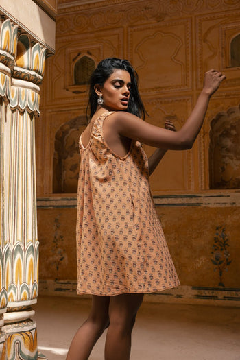 Sundress Mini Peach — studio back view, open back silhouette, mini hemline, tie-gather neckline detail, hand block print peach cotton mini sundress, artisan Jaipur India | Daughters of India