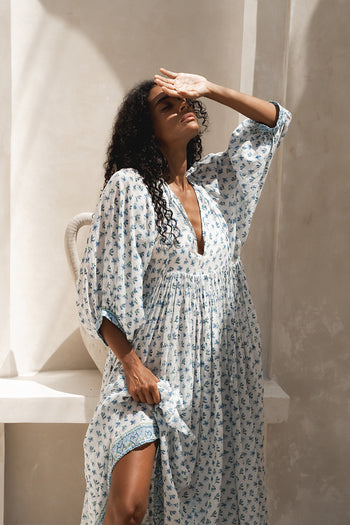Daughters of India Kyra Maxi Dress in Azure — shielding eyes in sunlight, flowing blue floral block print cotton maxi