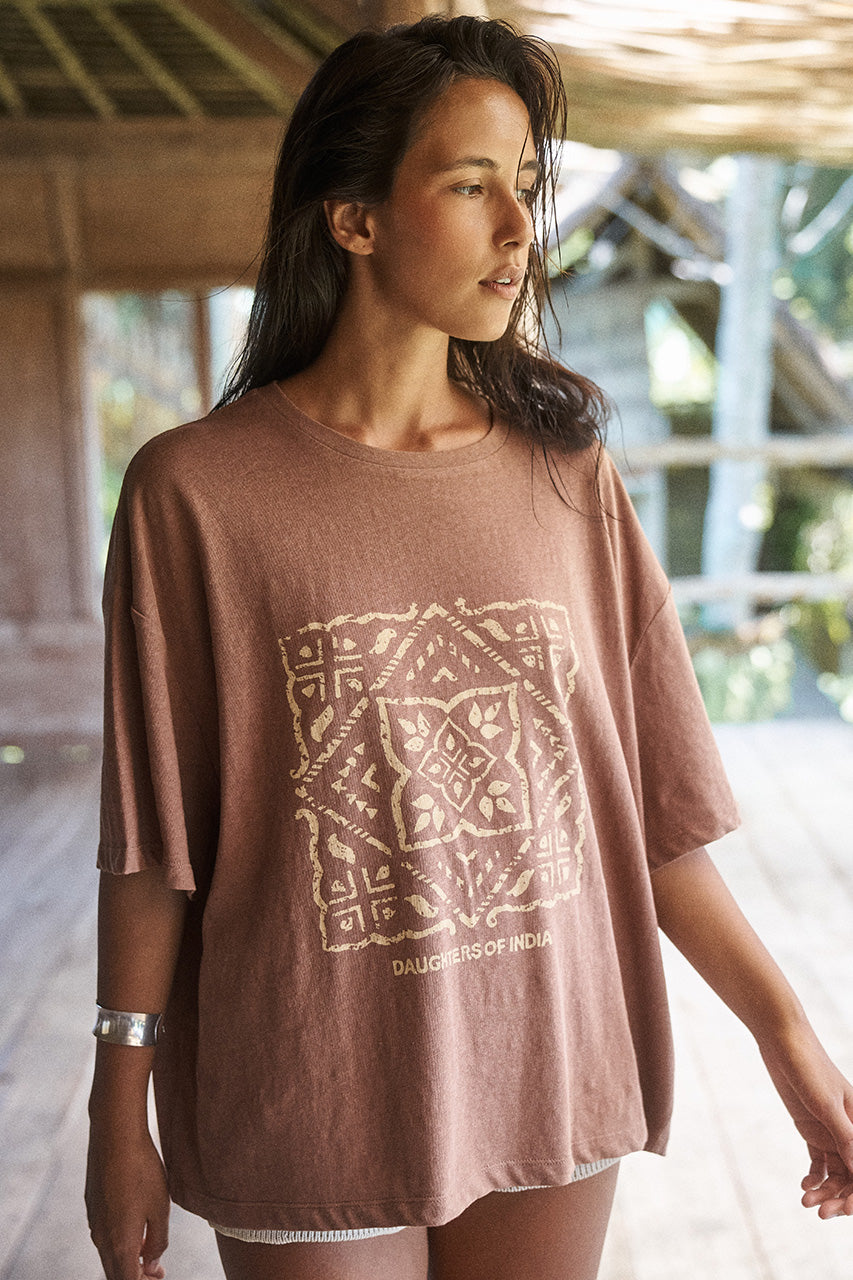 Side profile of woman wearing the Daughters of India Shanti Tee in Hazel, an oversized brown block print t-shirt, outdoors with natural lighting