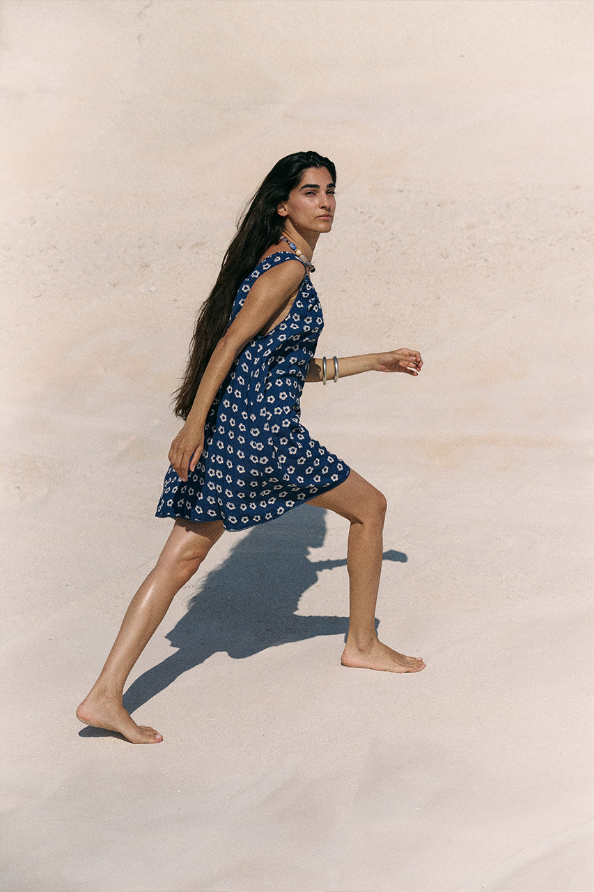 Sundress Mini Indigo — full length walking on sand, hand block print indigo mini dress in motion | Daughters of India